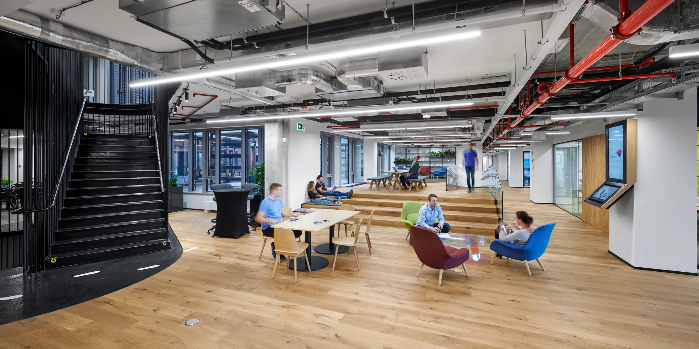 HB Reavis headquarters shared workspace with stairs, seating, and informal meeting areas.