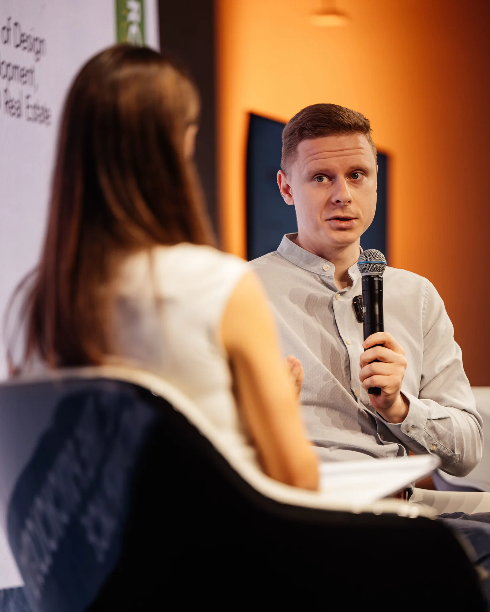 Michal Matlon speaking with another person during a discussion.