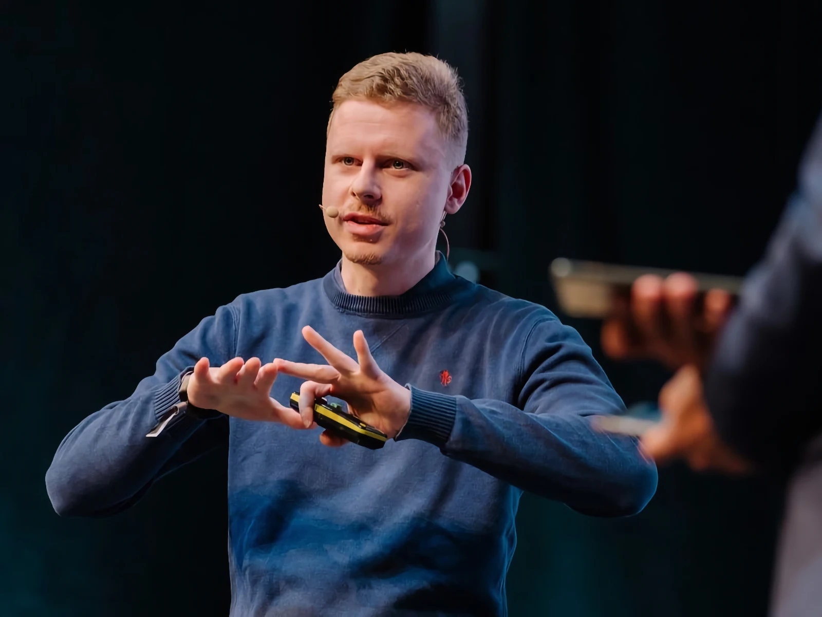 Michal Matlon speaking into a microphone during a discussion.